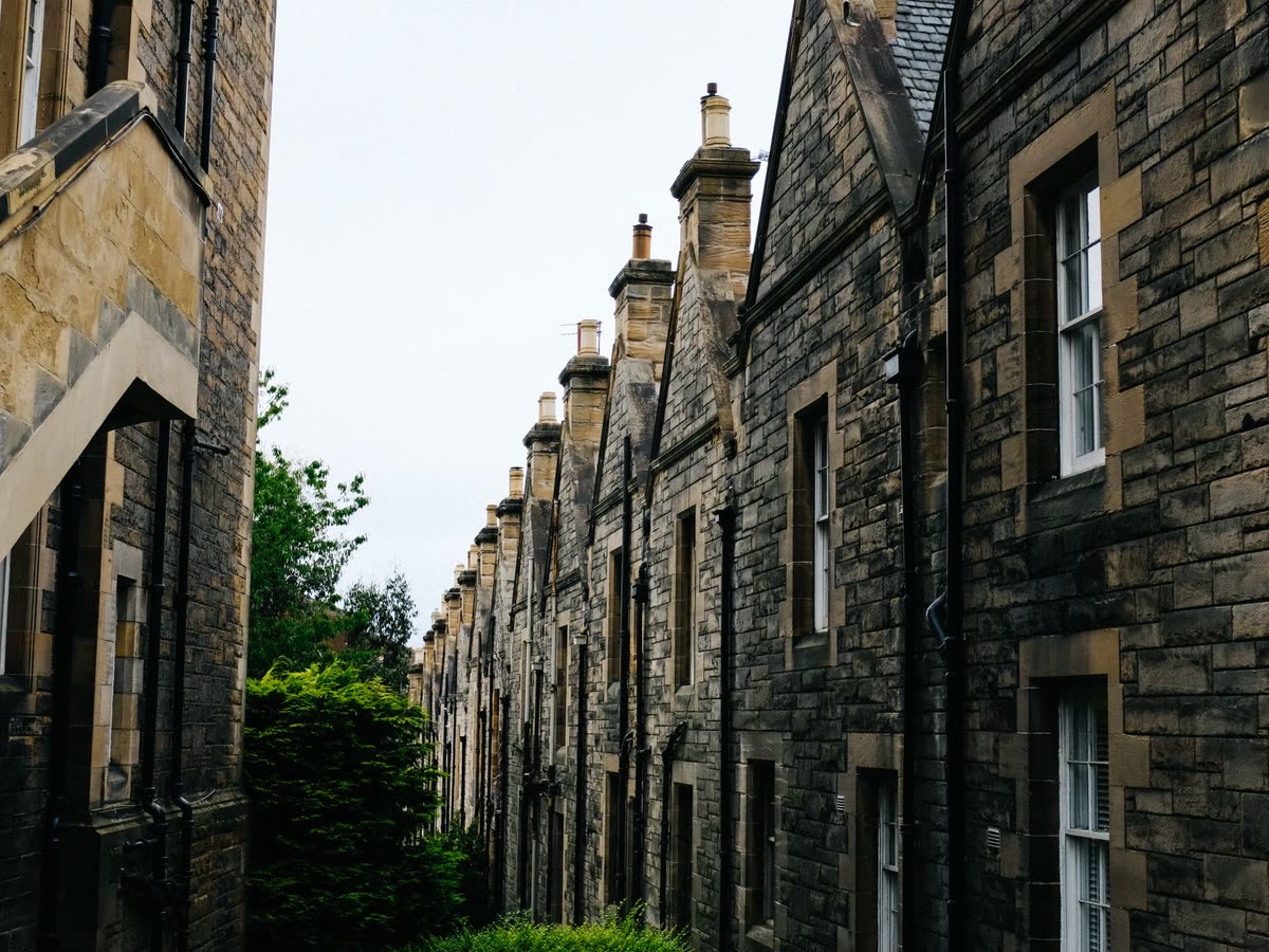 A stone terrace of rented houses on a quiet street